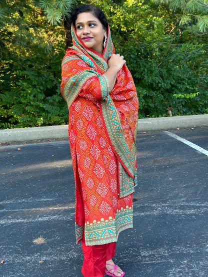 Orange Bandhani print Chinon silk suit highlighted with pearl, Cutdana & thread hand work