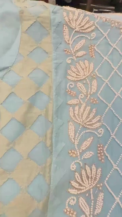 Sky blue pure Mulmul Pearl suit highlighted with and pearl & Cutdana handwork