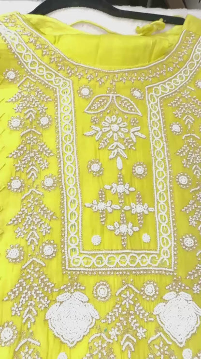 Lime yellow pure Mulmul Pearl suit highlighted with and pearl & Cutdana handwork